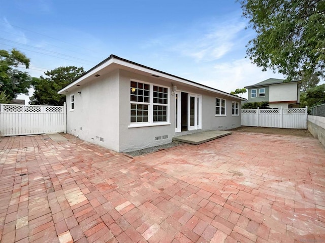 back of property with a patio