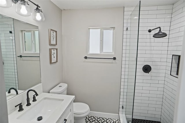 bathroom featuring vanity, a shower with shower door, toilet, and tile patterned floors