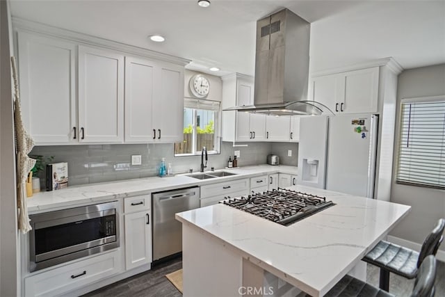 kitchen featuring a center island, sink, white cabinets, island exhaust hood, and stainless steel appliances