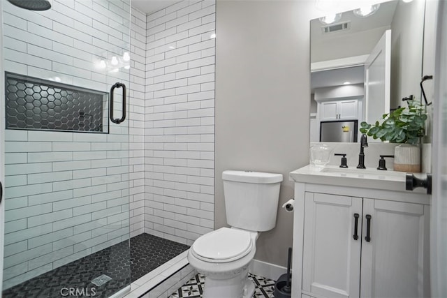 bathroom with vanity, a shower with shower door, toilet, and tile patterned flooring