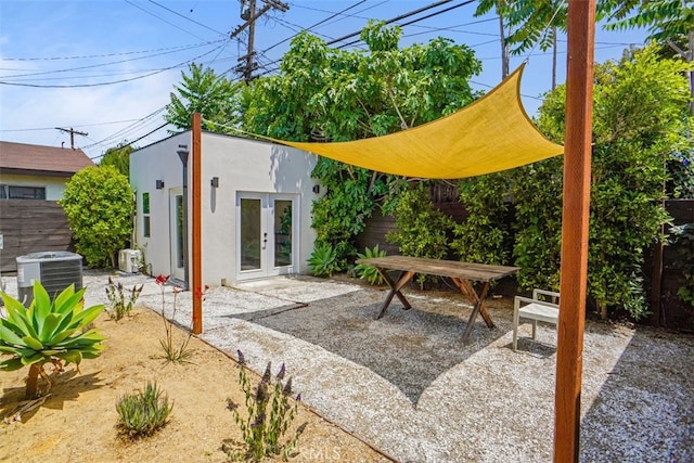 view of patio with central AC unit and french doors