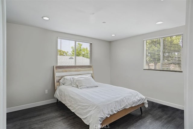 bedroom with dark wood-type flooring