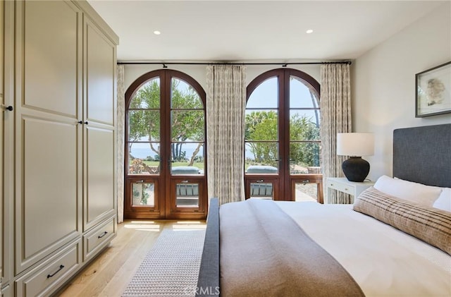 bedroom with light hardwood / wood-style flooring and french doors