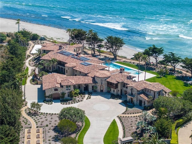 birds eye view of property with a beach view and a water view