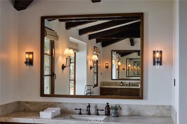 bathroom with vaulted ceiling with beams and vanity