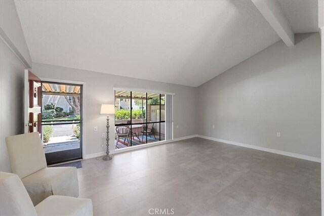 living room featuring vaulted ceiling with beams