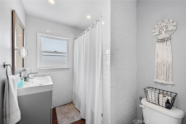 bathroom with vanity, hardwood / wood-style flooring, and toilet