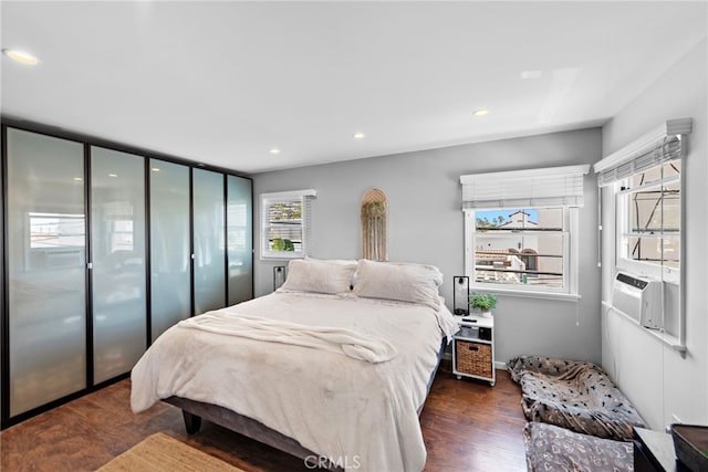 bedroom featuring cooling unit and dark wood-type flooring