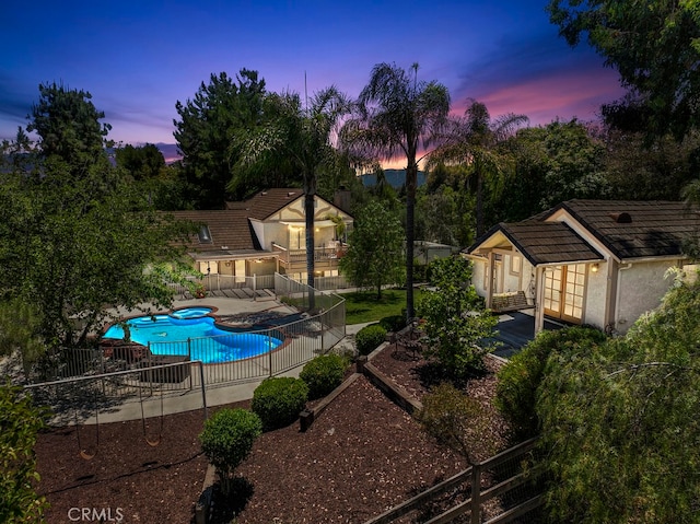 pool at dusk with a patio