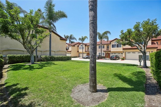 exterior space with a front yard and a garage