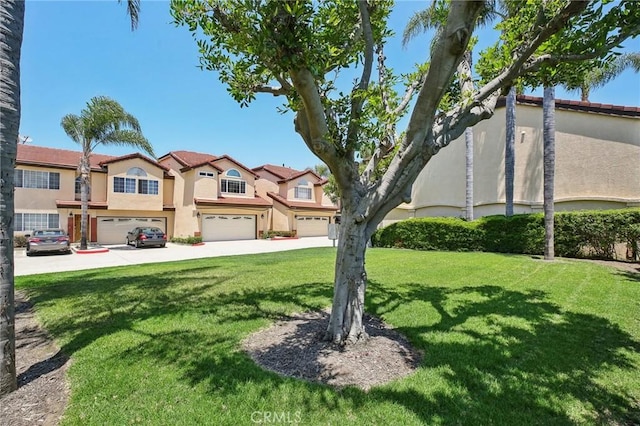 view of front of home with a garage and a front lawn