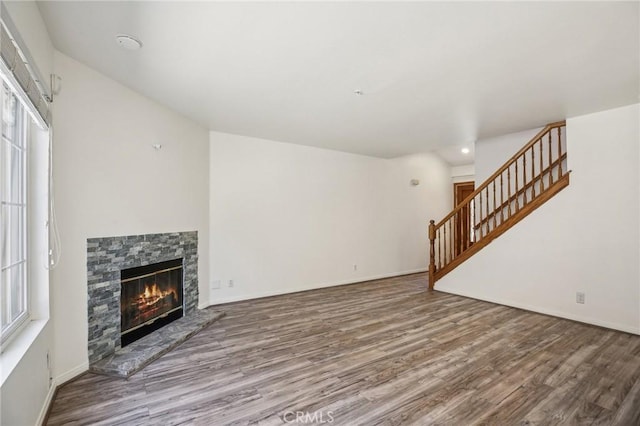 unfurnished living room featuring hardwood / wood-style flooring and a fireplace