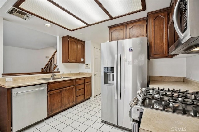 kitchen featuring sink, light tile patterned flooring, and appliances with stainless steel finishes