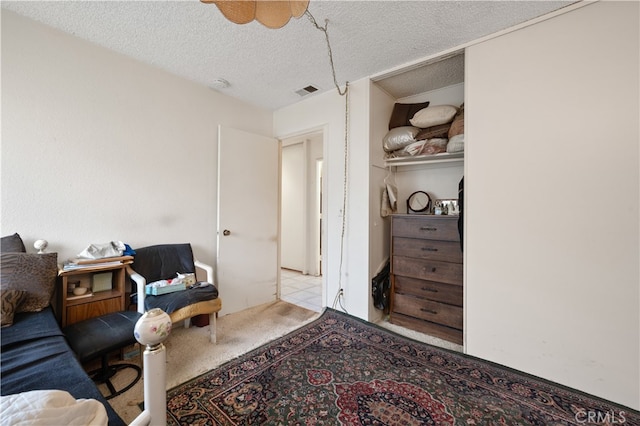 interior space with light carpet and a textured ceiling