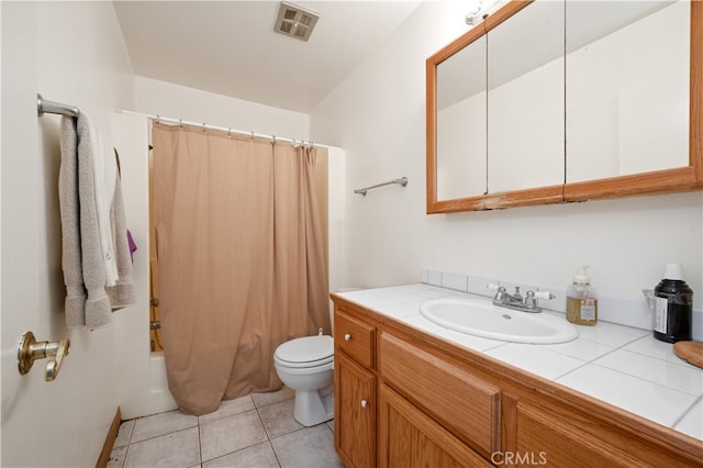 full bathroom featuring tile patterned floors, vanity, toilet, and shower / bath combo