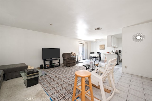 tiled living room featuring ceiling fan