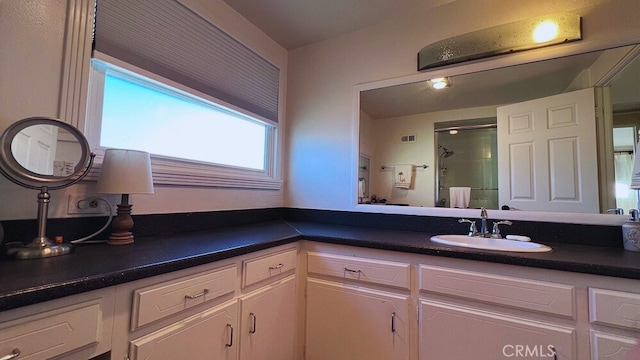 full bath with visible vents, a stall shower, and vanity