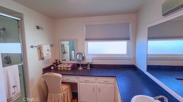 bathroom featuring visible vents, a stall shower, a wall mounted air conditioner, and vanity