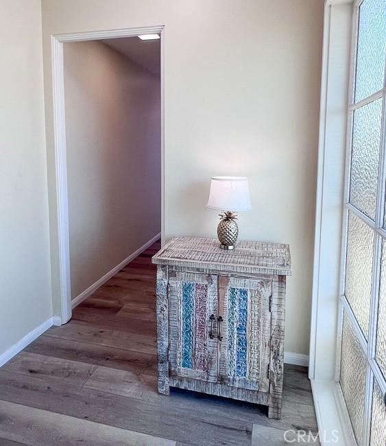 details featuring wood finished floors and baseboards