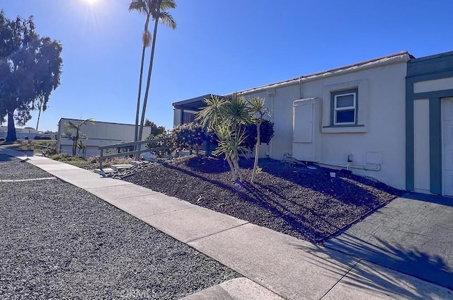 view of side of property with stucco siding