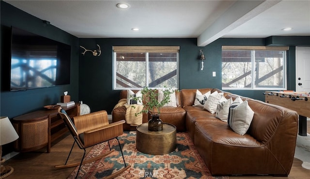 sitting room featuring beamed ceiling, hardwood / wood-style flooring, and plenty of natural light