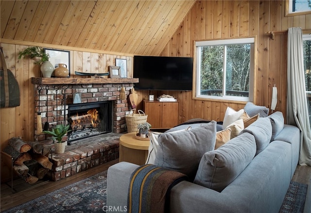 living room featuring high vaulted ceiling, wood-type flooring, a brick fireplace, and wooden walls