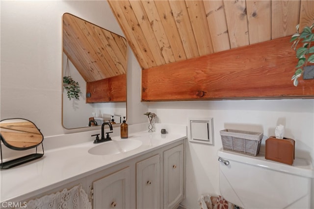 bathroom featuring vanity, toilet, wooden ceiling, and vaulted ceiling