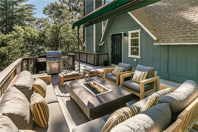 wooden deck with an outdoor living space with a fire pit