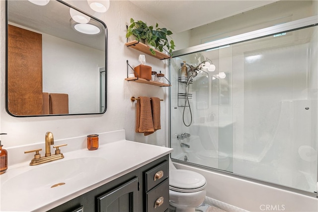 full bathroom with vanity, toilet, and shower / bath combination with glass door