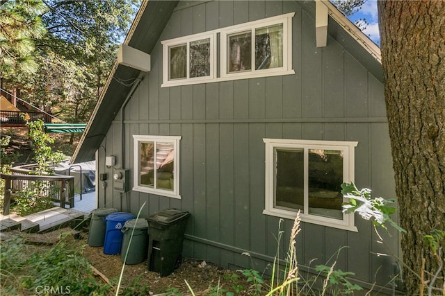 view of side of home featuring a wooden deck