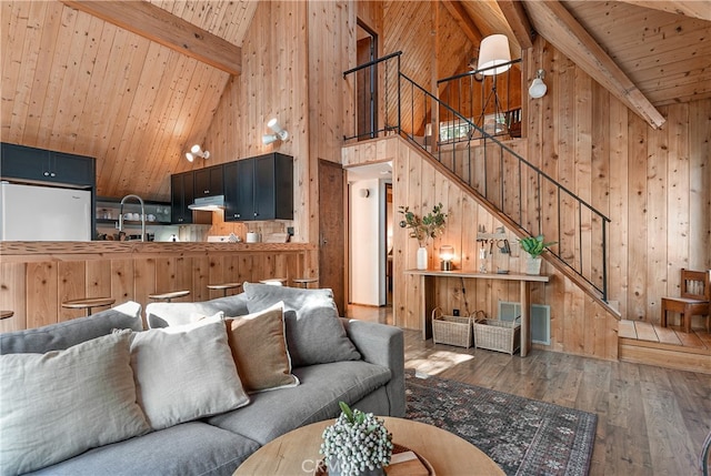 living room with wood ceiling, dark hardwood / wood-style flooring, high vaulted ceiling, beamed ceiling, and wooden walls