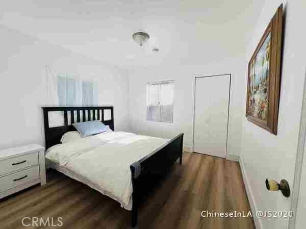 bedroom with dark hardwood / wood-style floors