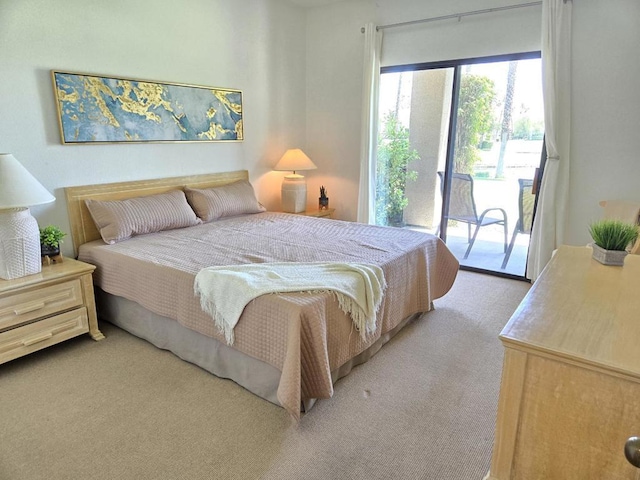 bedroom featuring light carpet and access to outside