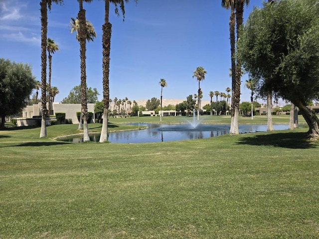 exterior space with a water view and a yard