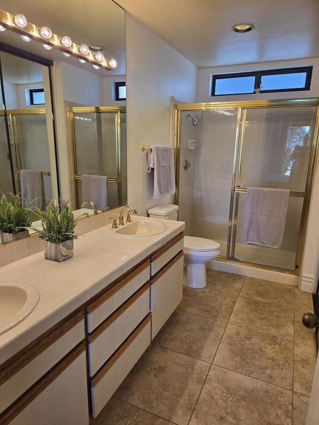 bathroom with toilet, vanity, and walk in shower