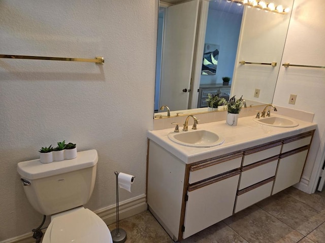 bathroom featuring tile patterned floors, vanity, and toilet