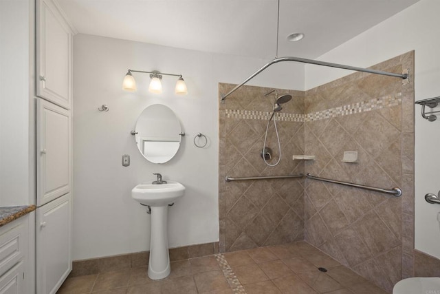 bathroom featuring a tile shower and tile patterned floors