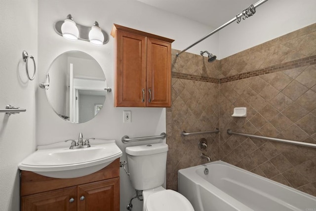 full bathroom featuring vanity, tiled shower / bath combo, and toilet