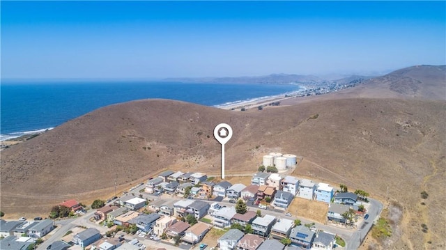 aerial view with a water view and a beach view