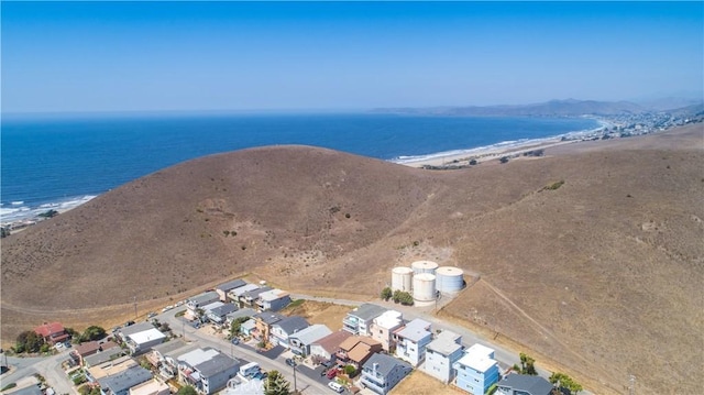 aerial view with a water view and a beach view