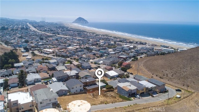 birds eye view of property with a water view and a view of the beach