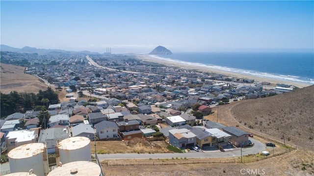 birds eye view of property with a beach view and a water view