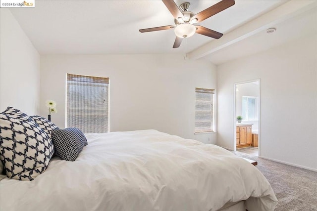 carpeted bedroom featuring vaulted ceiling with beams, ceiling fan, and ensuite bathroom