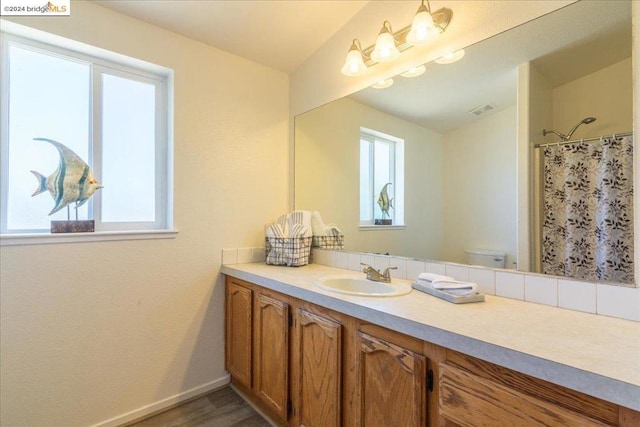 bathroom with vanity, toilet, a shower with shower curtain, and hardwood / wood-style flooring