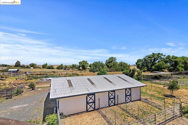 view of home's community featuring a rural view and an outbuilding