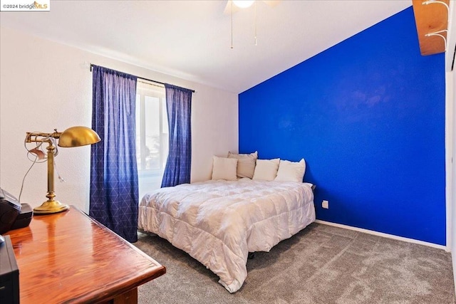 carpeted bedroom featuring vaulted ceiling and ceiling fan