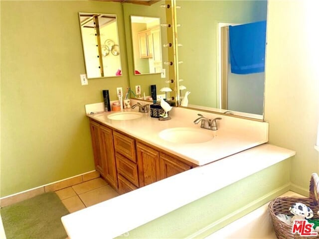 bathroom with tile patterned flooring and vanity