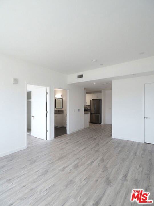 unfurnished living room featuring light wood-type flooring