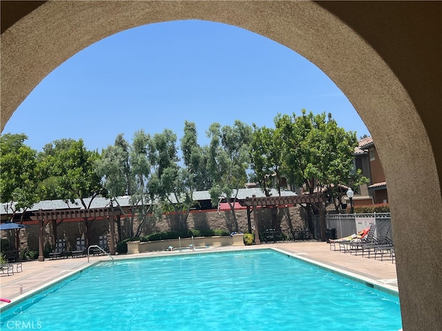 view of swimming pool featuring a pergola and a patio area