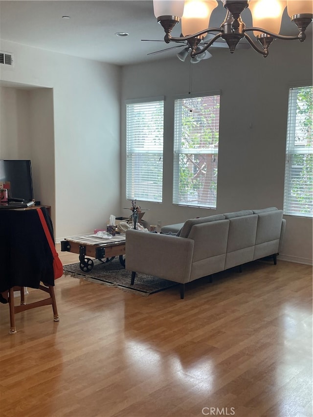 living room with hardwood / wood-style flooring and a chandelier